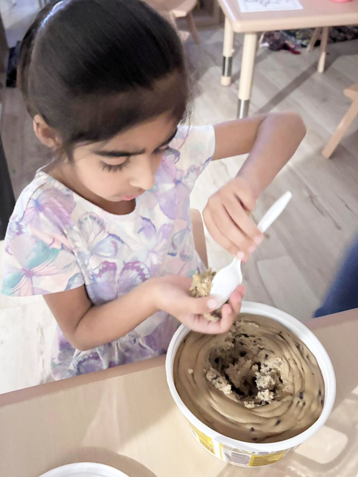 Child participating in a supervised cookie-baking activity