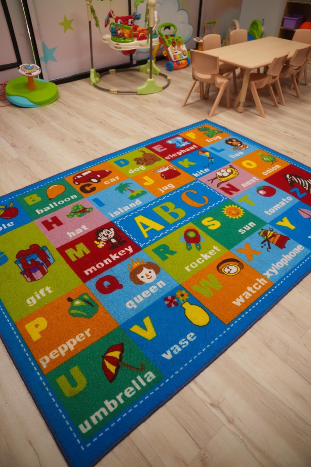 Alphabet rug and child-sized learning area at Starz R Us