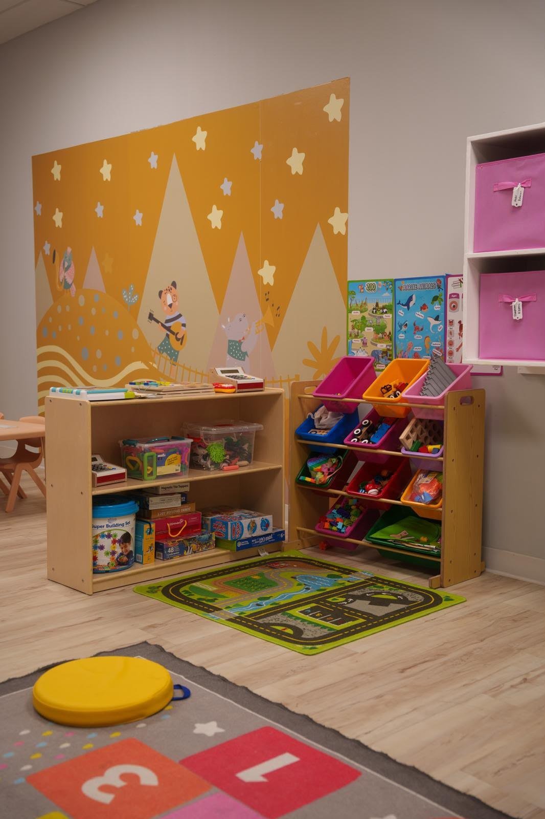 Classroom learning centers with books, puzzles, toys and colorful storage