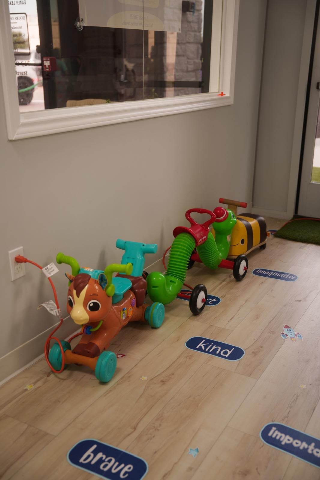 Ride-on toys arranged in a clean indoor activity area
